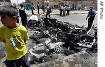 Iraqi policemen inspect the wreckage of a car bomb, in Baghdad, Iraq, 30 August 2006