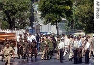 Syrian security officers gather in front the U.S Embassy after an attack in Damascus, Sept. 12, 2006