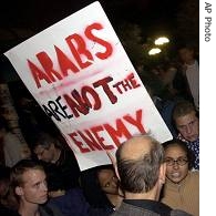 A woman carrying a sign supporting Arabs argues with a man  at New York's Union Square