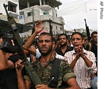 Palestinian security force officers march with their weapons during a protest demanding salaries from the Hamas-led Palestinian Authority in the streets of the Rafah Refugee Camp, in the Gaza Strip