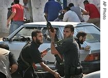 Bystanders, demonstrators take cover as Hamas militiamen take position and fire in the air, in Gaza City, October 1, 2006