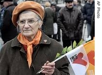 Ukranian demonstrator holds a flag of opposition leader Yulia Tymoshenko's party during a rally in Kiev, Nov. 22, 2006