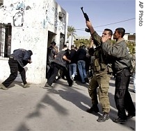 A Palestinian police officer fires into the air after he and others stormed the Legislative Council building, during a protest to demand their salaries from the Hamas-led Palestinian Authority in Gaza City