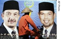 Acehnese man rides his bike past a campaign sign for one of parties contesting the election on Sunday Dec. 10, 2006 in Banda Aceh 