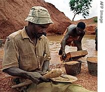 Men look into their sifter to find a diamond stone (File)