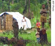 Angolan refugee boy stands in front of his family's shelter  (File photo)