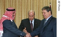 Palestinian Authority Prime Minister Ismail Haniyeh from Hamas, left, shakes hands with Rauhi Fattouh, an envoy of Palestinian President Mahmoud Abbas, right, 30 Jan. 2007