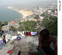 A boy watches a resident of the abandoned Ducor Hotel building, where they now take shelter, dry her clothes in Monrovia, Liberia (File)