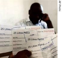 Unidentified man inspects his fuel coupons in Harare, after receiving them from a relative in London via Mukuru.com, 12 Jun 2007 