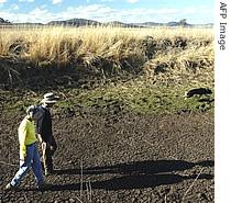 Australian farmers survey a dry creek bed on their drought stricken 100-hectare property near Toowoomba, west of Brisbane (File photo)