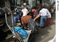 Iraqis board a bus to a neighboring Syria, in central Baghdad, Iraq, 20 June 2007