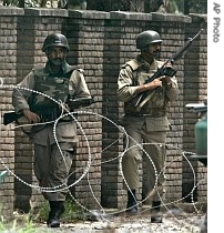 Pakistani paramilitary troops walk towards another position at main conflict area of Lal or Red Mosque in Islamabad, Pakistan, 7 July 2007