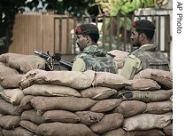 Pakistani army troops keep an eye on the area near Lal Masjid, or Red Mosque, in Islamabad, 11 July 2007