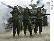 Israeli gunners cover their ears as an artillery piece fires into southern Lebanon from a position on the border near Kiryat Shmona, northern Israel , Saturday, July 15, 2006