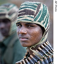 A Tamil Tiger fighter with machine gun bullets around his neck at a training camp in an undisclosed location deep in Tiger controlled territory, northeast of Colombo, Sri Lanka, 13 July 2007