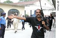 Pakistani commandos clear area as chief cleric of Islamabad's radical Red mosque Maulana Abdul Aziz arrives at Anti-Terrorist court in armored car in Rawalpindi, 12 Jul 2007