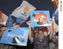 Supporters of Justice and Development Party hold posters of PM Recep Tayyip Erdogan as they wave party flags outside of party headquarters in Ankara, 22 July 2007