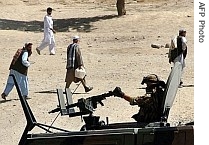 An Italian soldier with the NATO-led International Security Assistance Force (ISAF) blocks a road near the site of a suicide attack on the outskirts of Kabul, 18 July 2007