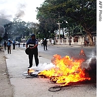 United Nation peacekeeping soldiers try to control a fire, set on a cycle-van in Dili, 06 August 2007