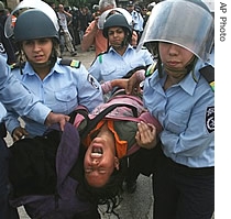 Israeli police officers carry a Jewish settler as he is evacuated from a house in the West Bank town of Hebron, 07 Aug 2007