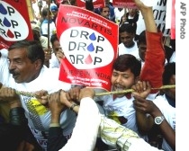 Indian people infected with HIV and activists hold placards and shout slogans against harmaceutical firm Novartis during a demonstration in New Delhi, 29 Jan 2007