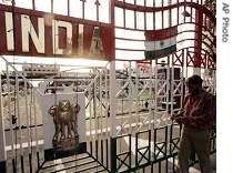 An electrician checks the decorative lights on the Indian gate, at the joint border check post, Wagah, India, 13 Aug 2007