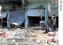 An Iraqi boy picks through the rubble after a coordinated suicide attack in town of Qahataniya, 120 kilometers west of Mosul, Iraq, 15 Aug 2007