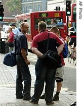 Polish workmen with their work clothes and tools, stand around on a street corner in Hammersmith, west London