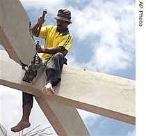 An Indonesian man works on rebuilding a structure in an area devastated by May's earthquake in Pleret, Yogyakarta, Indonesia, Monday, October 2, 2006