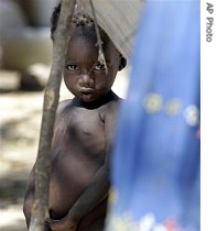 A young refugee child stares from a makeshift camp set up by villagers forced from their home in the latest cycle of ethnic violence that has spilled over from Sudan's neighboring Darfur province to eastern Chad