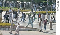 Protesters throw stones at police during anti- government rally in Islamabad, 16 Mar. 2007