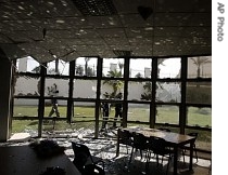 Palestinians check the damage at an American International School in the northern Gaza Strip town of Beit Lahiya, Saturday 21 Apr 2007