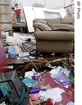 Lorenzo Tijerina, 9, (r) and his brother, Armondo, 5, look through the debris of their neighbor's home in Eagle Pass, Texas, 25 Apr 2007