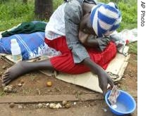 A woman begs in a street in Harare, Zimbabwe (File)