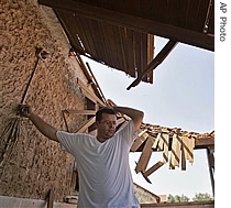 Israeli Yair Elbaz reacts after a rocket fired from the Gaza Strip hit a house he owns and rents to students in the southern Israeli town of Sderot, 18 May 2007