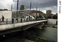 Kosovo Police patrol on the main bridge of the ethnically divided town of Mitrovica