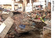 Pakistani tribesmen gather around a destroyed paramilitary check post after a blast in Miranshah, the main town in North Waziristan, 17 Jul 2007