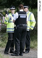 British police officers block a public footpath leading to a farm outside Normandy, England, where a nsecond outbreak of foot-and-mouth disease was was announced Tuesday, 7 Aug. 2007